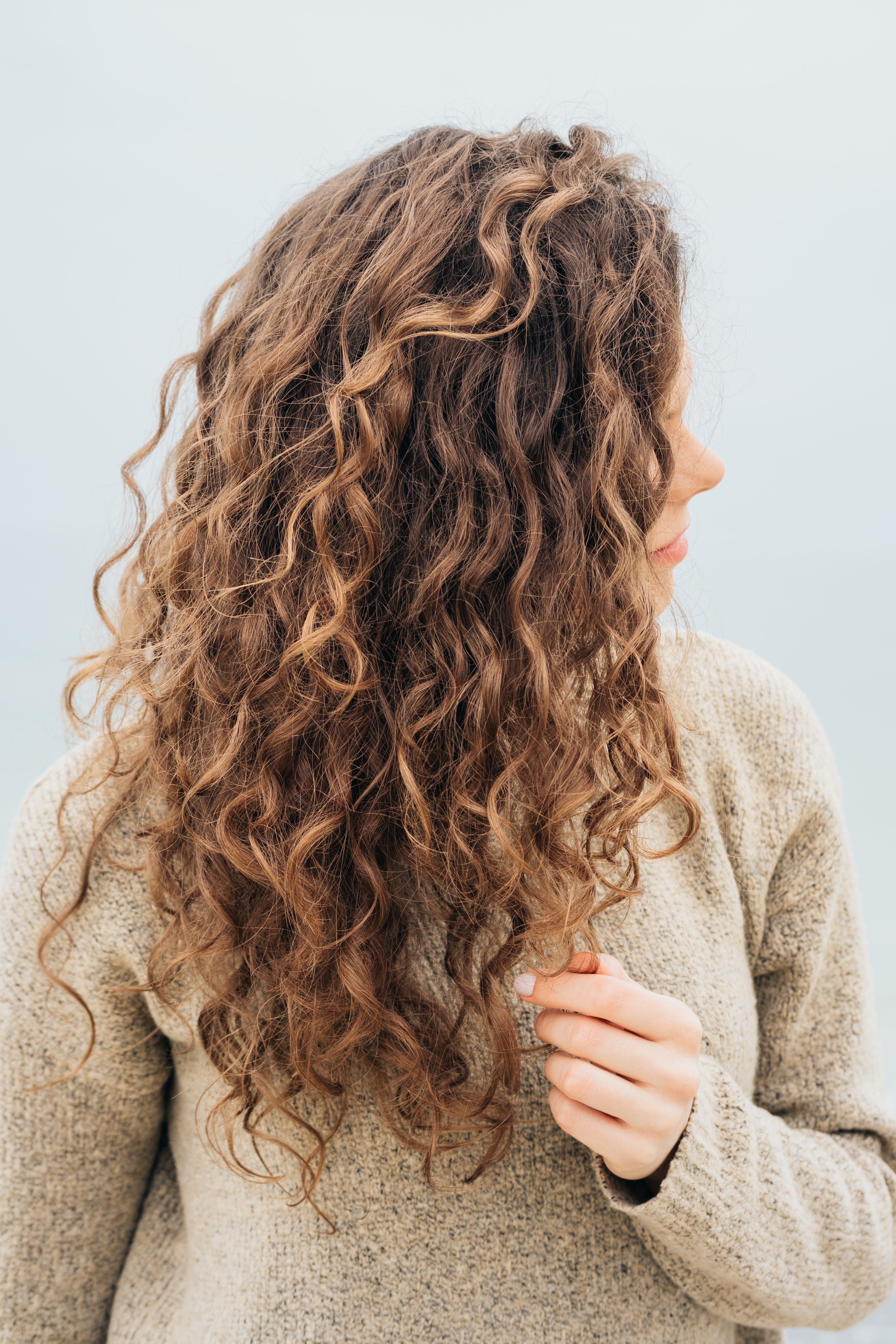 Woman with long brown curly hair