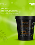 Black body scrub container with text on a green background, featuring Organic Mimi branding.