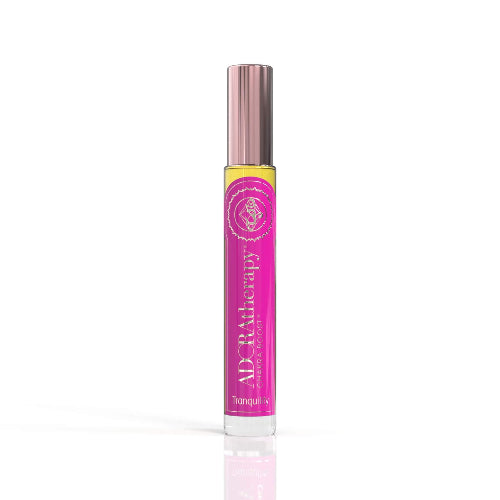A roll-on perfume oil bottle with a pink label displaying the brand and product name, ADORAtherapy.