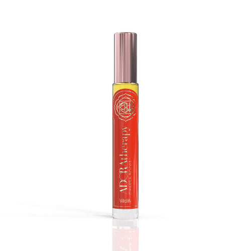 A roll-on perfume oil bottle with a pink cap, labeled 'Chakra 1 Vitality' by ADORAtherapy.