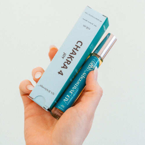 Chakra 4 roll on with box in hand