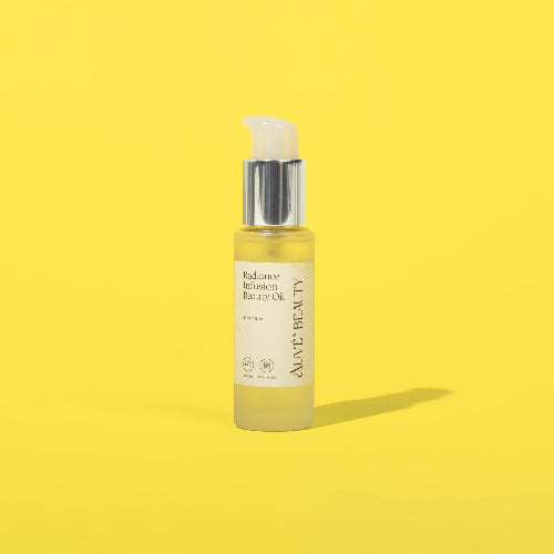Auve Beauty Radiance Infusion Beauty Oil with yellow backgorund