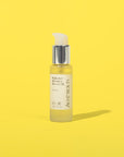 Auve Beauty Radiance Infusion Beauty Oil with yellow backgorund