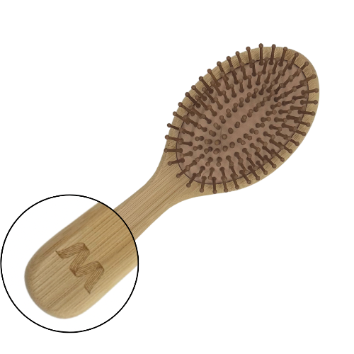 Wooden hairbrush with close-up of handle on a white background