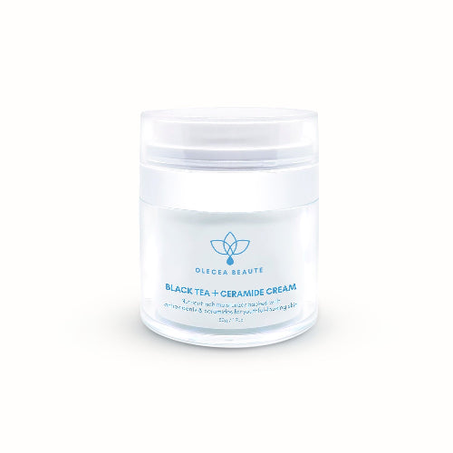 A jar of Olecea Black Tea + Ceramide Cream with a white and blue label, indicating it is a skin care product.