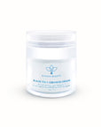 A jar of Olecea Black Tea + Ceramide Cream with a white and blue label, indicating it is a skin care product.