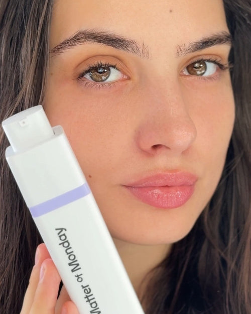 Woman holding a 'Matter of Monday' skincare product