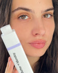 Woman holding a 'Matter of Monday' skincare product