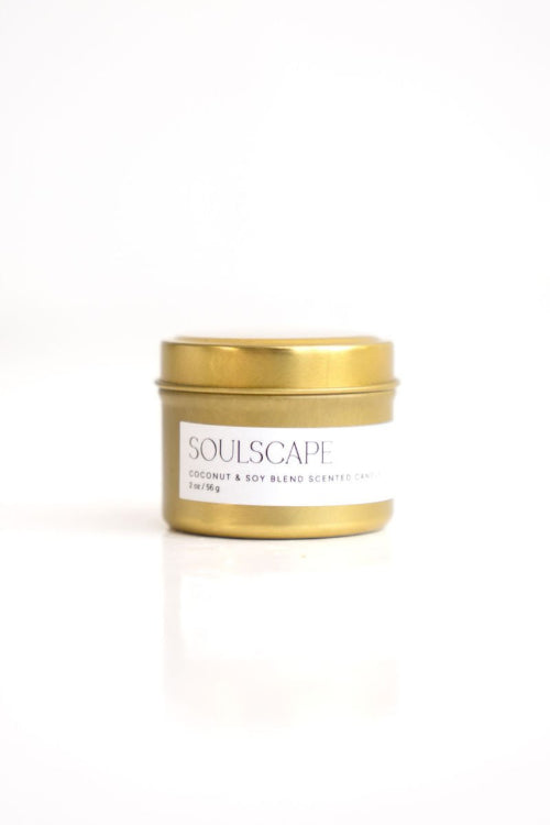 A white candle with a wooden lid and a label that reads 'SoulScape'. The candle is placed against a white background.