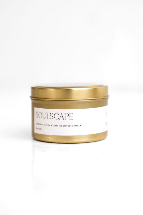 A white candle with a wooden lid and a label that reads 'SoulScape'. The candle is placed against a white background.