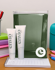 Two Envio skin care tubes on a desk with stationery items.
