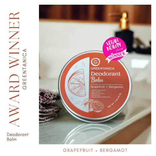 Deodorant balm container with 'Greenitanica' branding on a bathroom counter.
