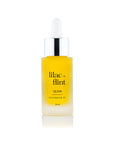 Yellow bottle of lilac + flint Glow Microbiome Oil on a white background
