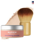 Naprim naturals nourishing powder with a brush on a white background