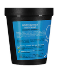 Body butter container with blue label and black lid on a teal background