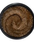 Brown paste in a black container on a transparent background