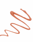 Smeared beige makeup product on a white background
