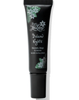 Black skincare tube labeled 'Island Nights' with floral designs on a white background