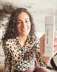 Woman holding a 'Matter of Monday' product against a rustic wooden background