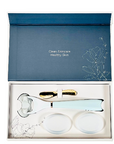 A deluxe gift set by LUNAESCENT containing a skincare applicator and two silicone pads, presented in a luxury keepsake box with a gold-colored low-scoop spatula.