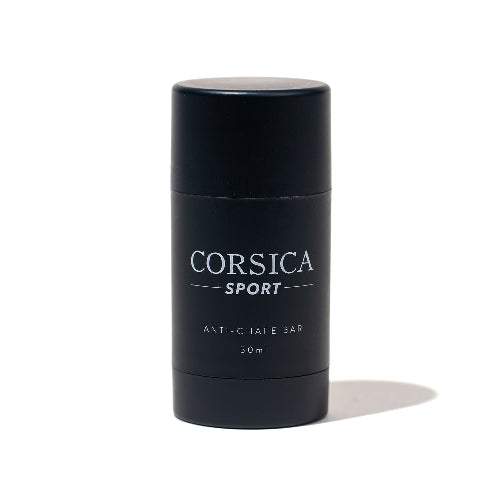 A black cylindrical container labeled 'CORSICA SPORT ANTI-CHAFE BAR' with white text indicating the product is a 50ml anti-chafe bar.