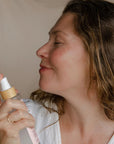 Woman spraying Rose Toner