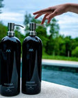 2 Pro-ocean bottles outside with hand reaching