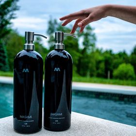 Pro ocean bottles by pool with hand reaching