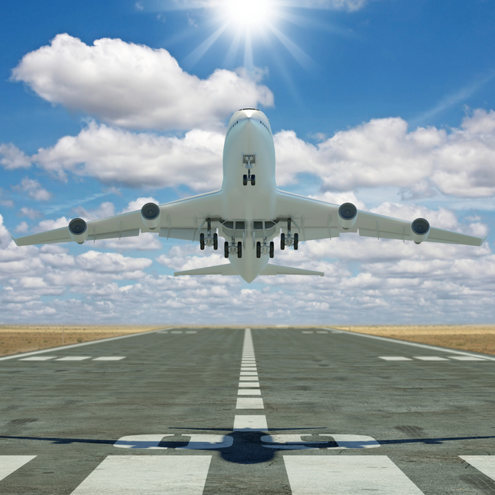 Picture of an airplane taking off in sunny, blue skies