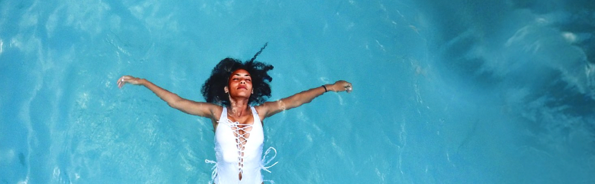 Woman floating in blue ocean