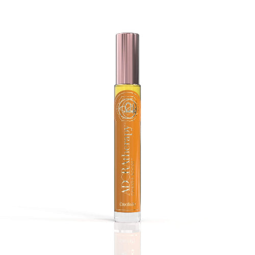 A roll-on perfume oil bottle with a pink cap, labeled 'Chakra 2' by ADORAtherapy.