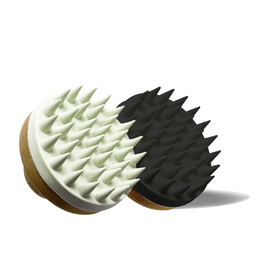Two massage brushes, one white and one black, on a white background.