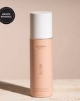 Aloesia Glow product bottle on a beige background with an award badge.