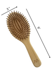 Wooden hairbrush with measurements on a white background