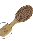 Wooden hairbrush with close-up of handle on a white background