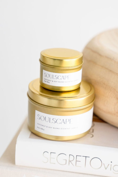 Stack of soulscape candles with travel tin on top of full size tin