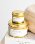 Stack of soulscape candles with travel tin on top of full size tin