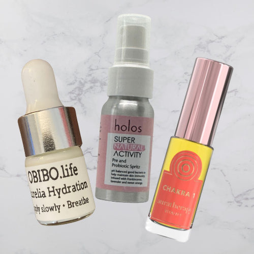 Three skincare products on a marble background