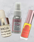 Three skincare products on a marble background