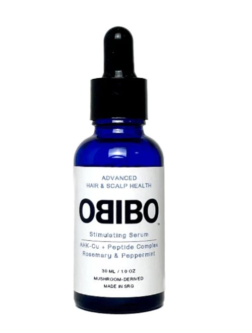 A 30 mL cobalt blue glass dropper bottle of OBIBO Stimulating Serum with a white label and black dropper cap, set against a plain white background.