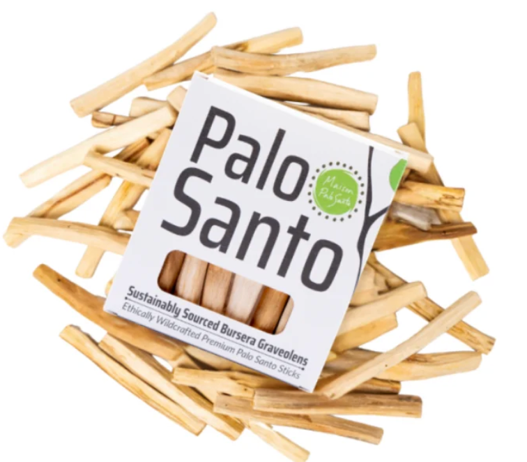 A box of Palo Santo sticks surrounded by scattered natural wood incense sticks on a plain white background.