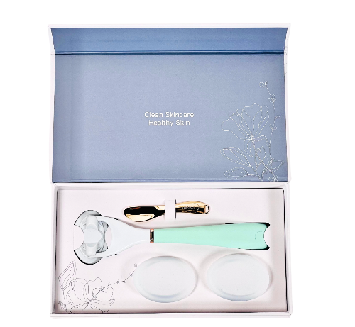 A deluxe gift set by LUNAESCENT containing a skincare applicator and two silicone pads, presented in a luxury keepsake box with a gold-colored low-scoop spatula.