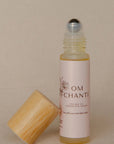Roll-up bottle with wooden cap on a beige background