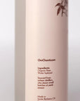 Product bottle with 'OmChantico' branding and ingredient details on a light background