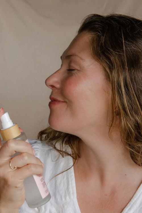 Woman spraying Rose Toner