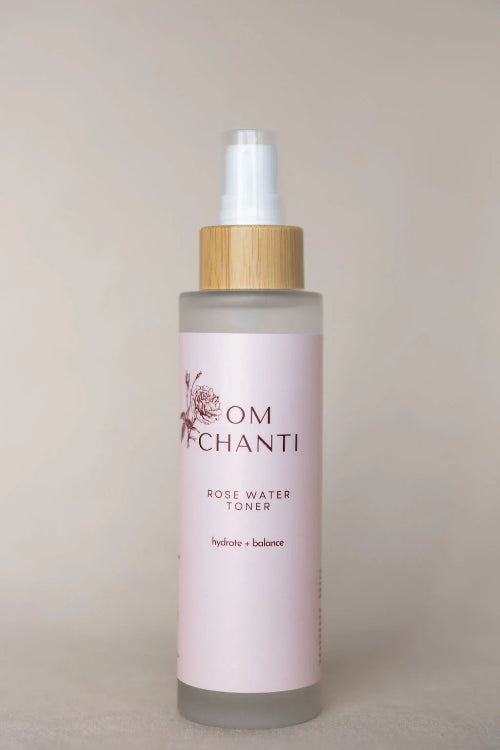 Bottle of Om Chanti rose water toner on a beige background