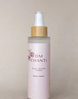 Bottle of Om Chanti rose water toner on a beige background