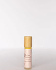 Skincare bottle with wooden cap on a light gray background