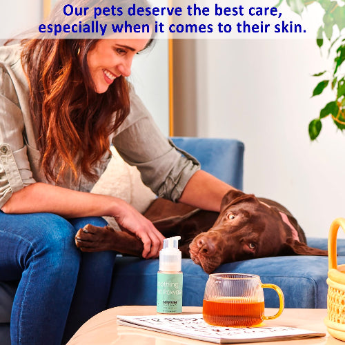 Woman petting a dog on a couch with a bottle of pet product and a mug in the foreground.
